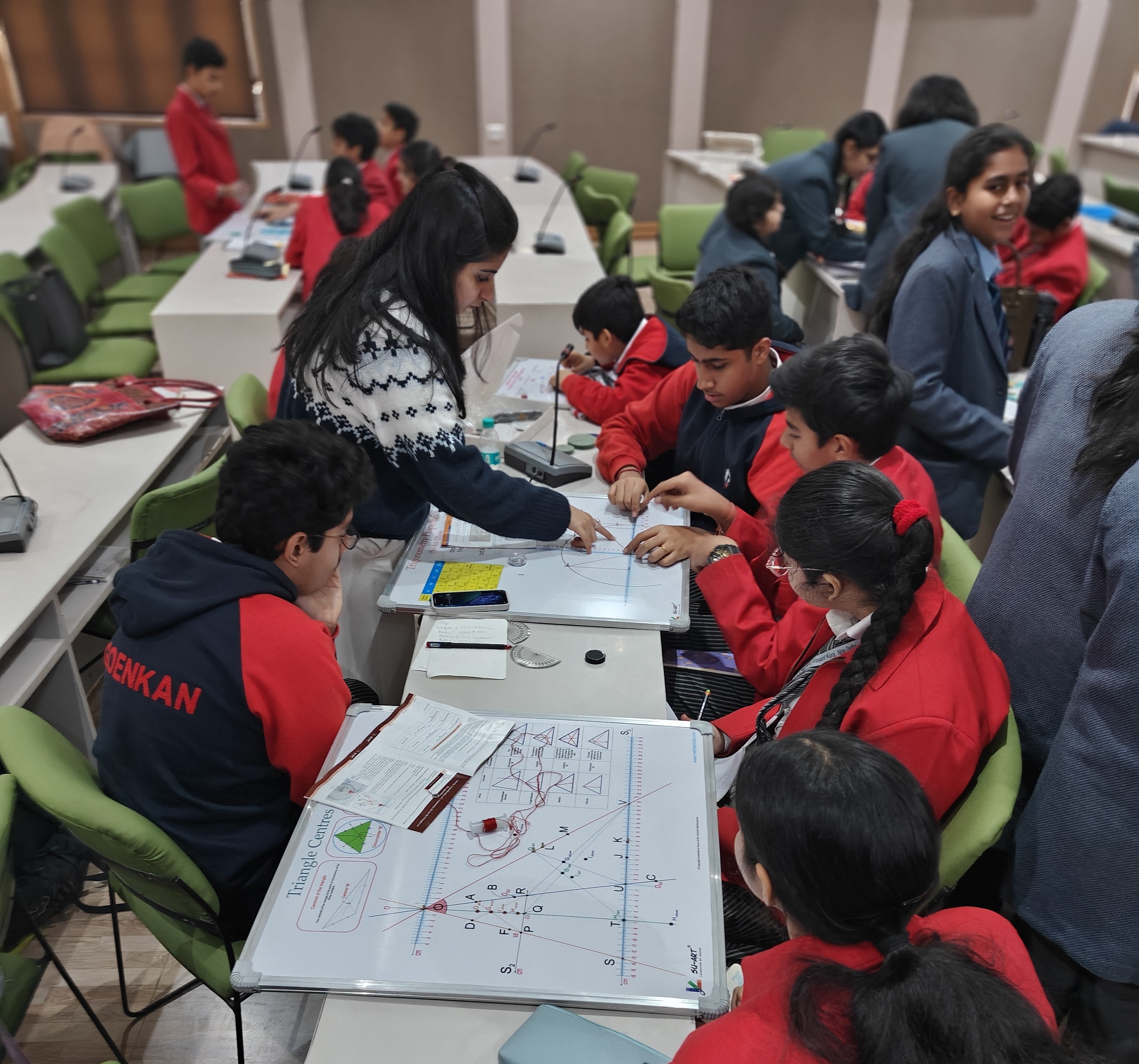 Students working together around a Su-Art mathematics apparatus
